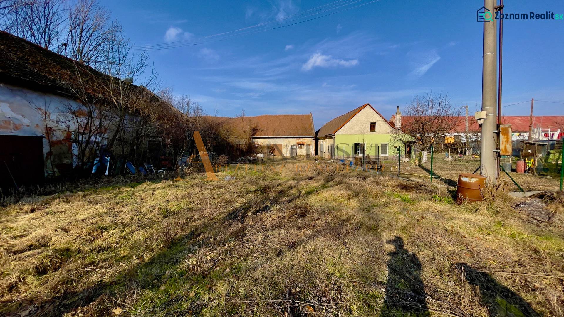 Buildings and an unmaintained plot in the production area on Hlavná Street in Kovarce.