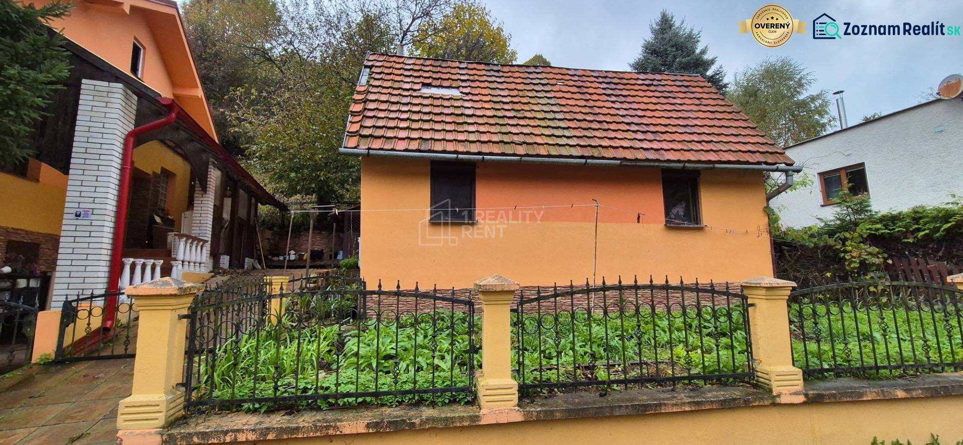 A family house in the village of Kolárovice on Škoruby with an orange facade and a vegetable garden.