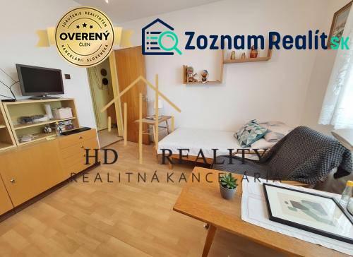 Living room in a three-room apartment with a wooden decor floor and furniture.