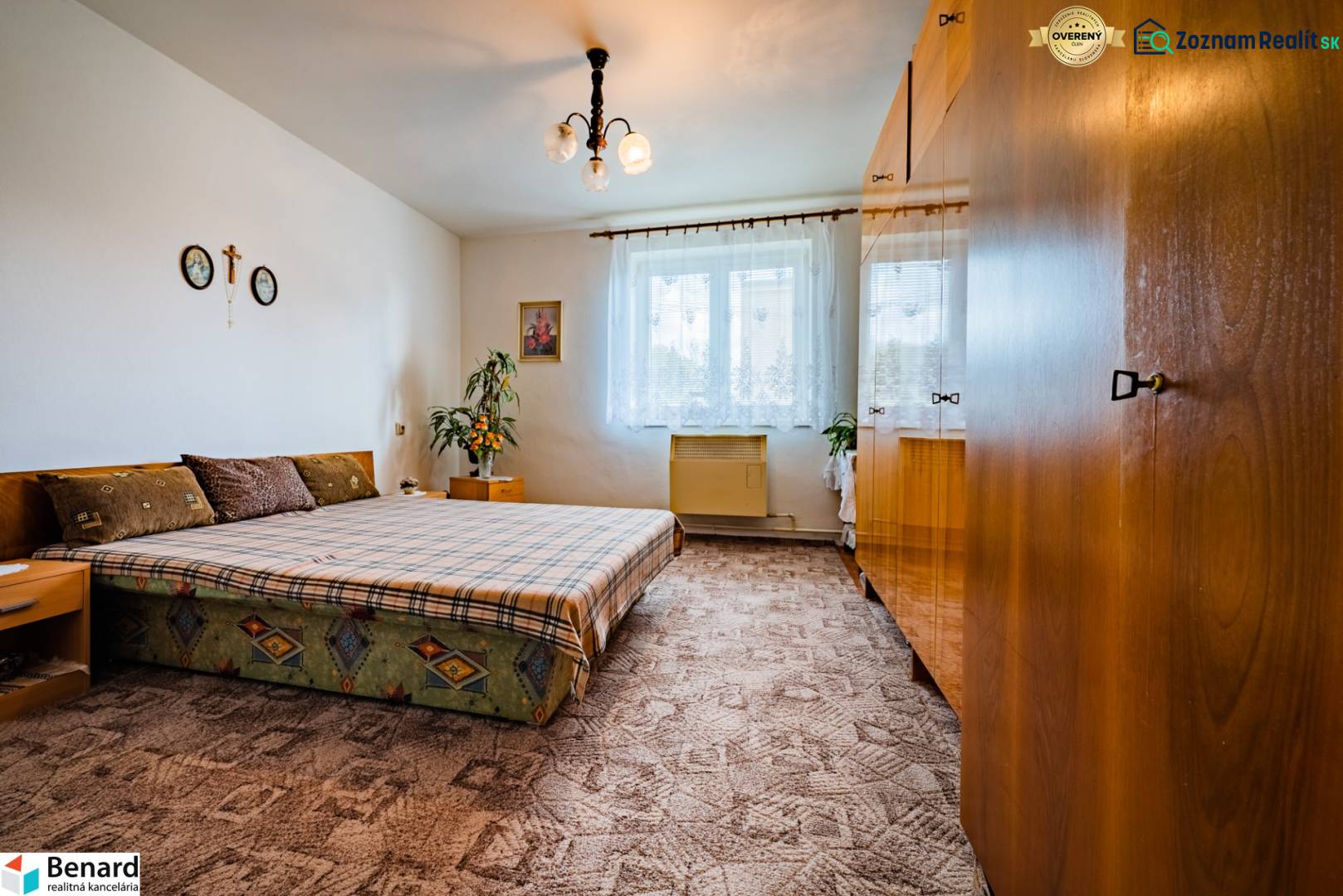 Bedroom in a 3-room apartment with a bed, wardrobes, and a carpet.