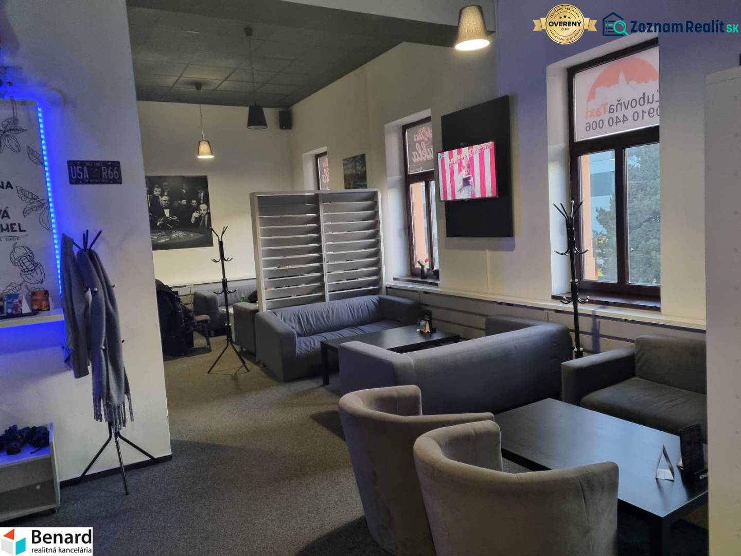 Bright commercial space with comfortable seating and a television on the wall.