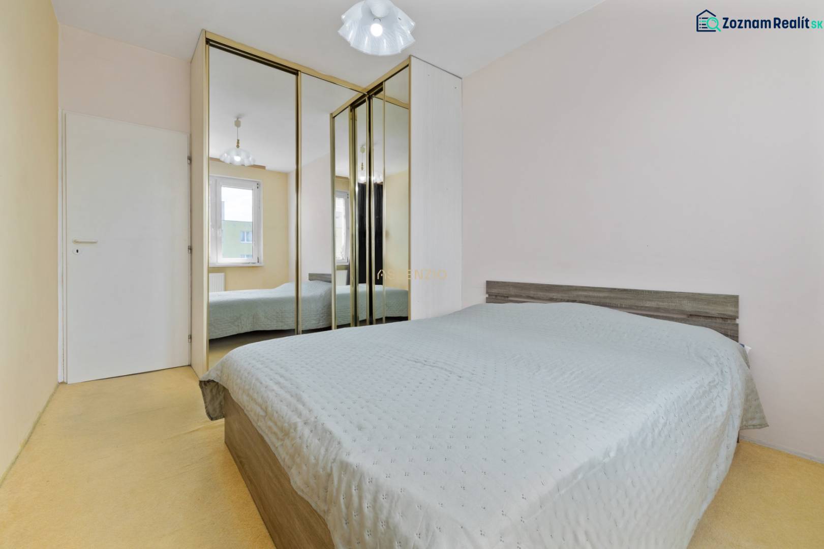A bedroom with a mirrored wardrobe in a 3-room apartment has a bed and a window.