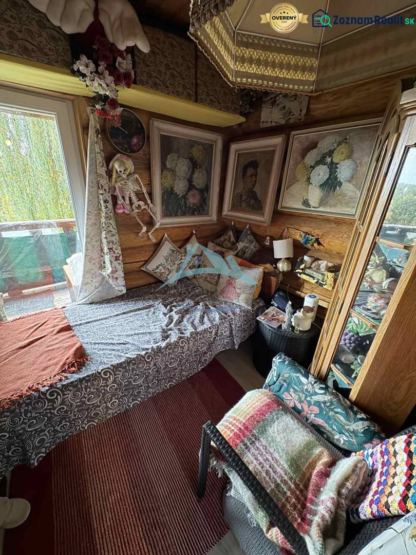 A cottage with rich decorations, a comfortable sofa, and decorative paintings on the walls.