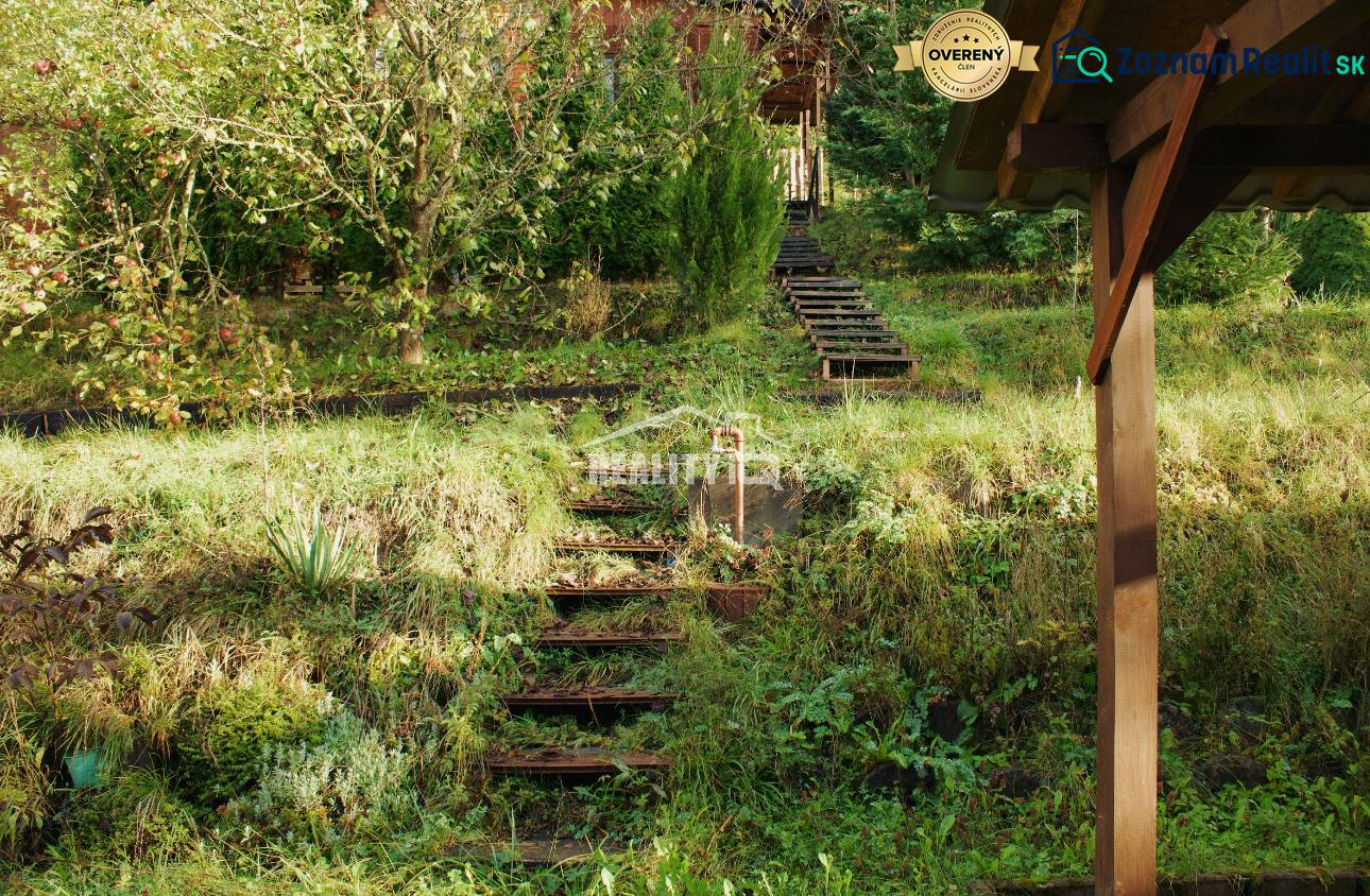 Stairs leading through a sloping garden with lush vegetation in Budatín, Žilina.