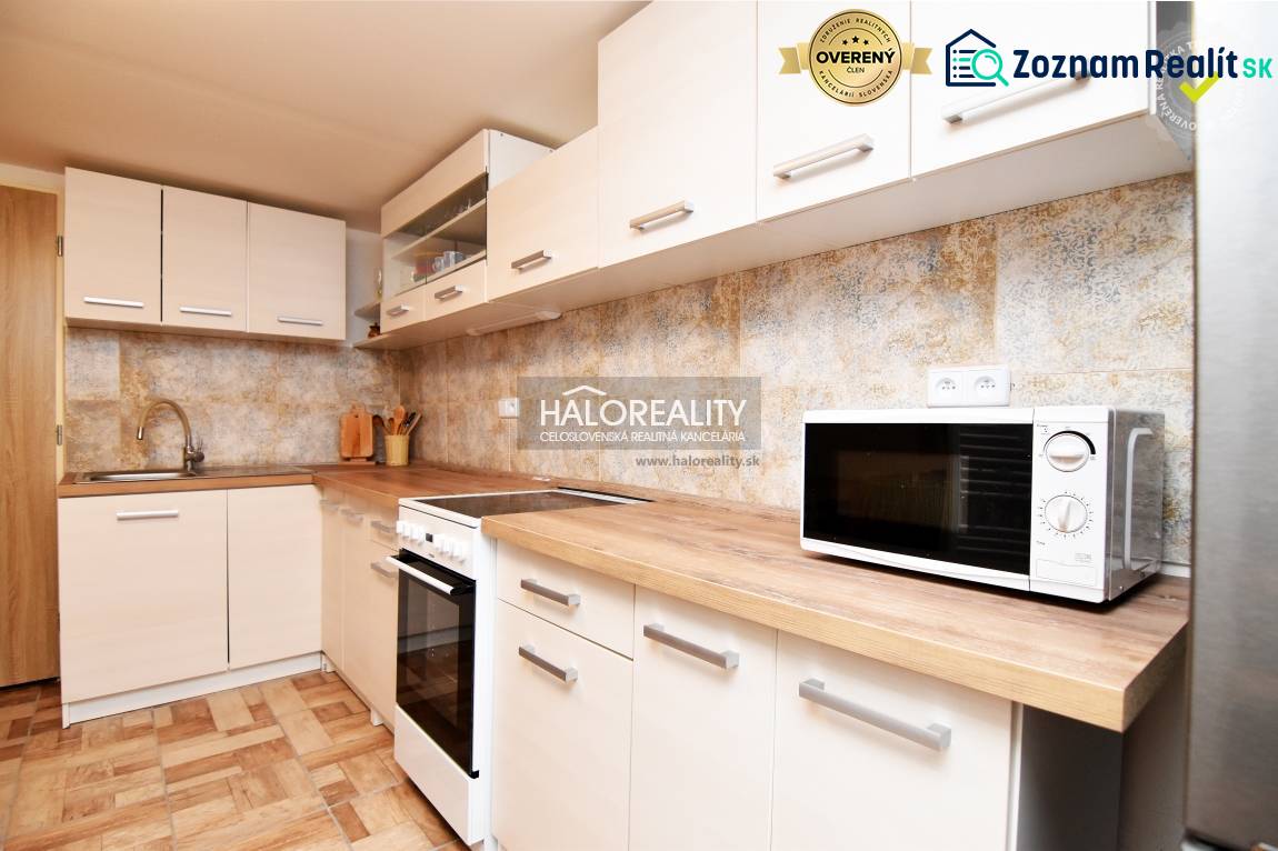 A kitchen with cabinets, appliances, and a wooden decor floor in the interior of Gardens.