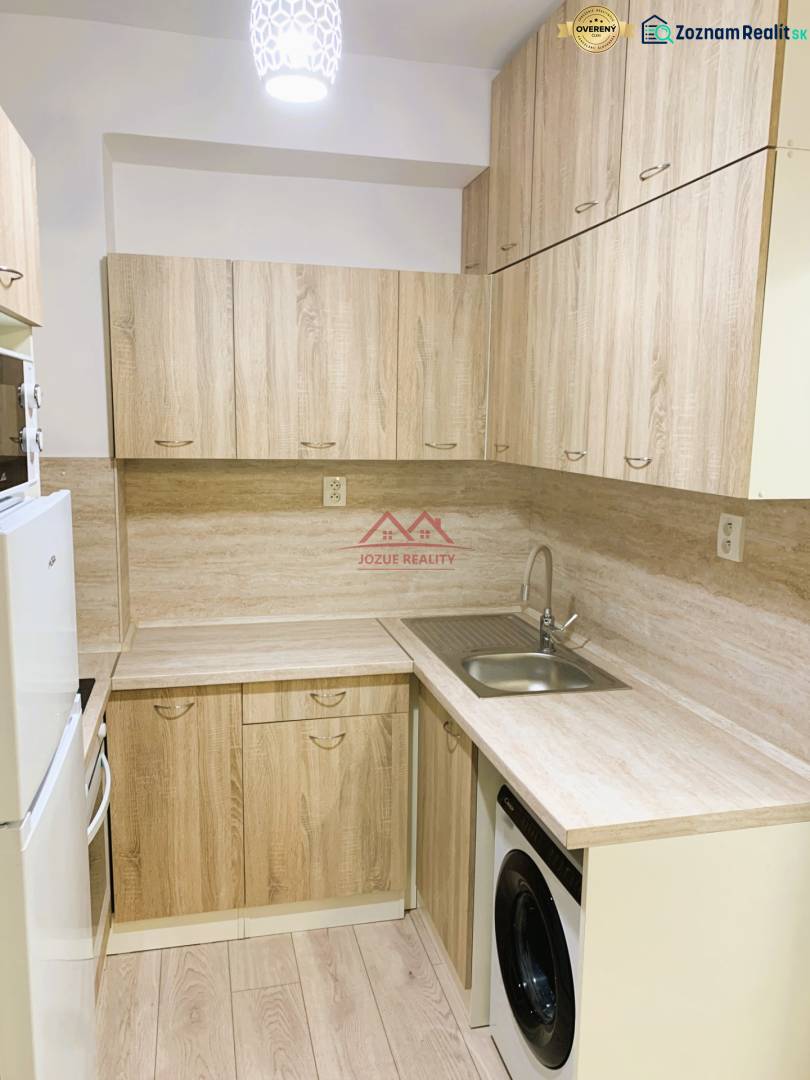 A kitchen unit in a 3-room apartment with a wooden decor and built-in appliances.