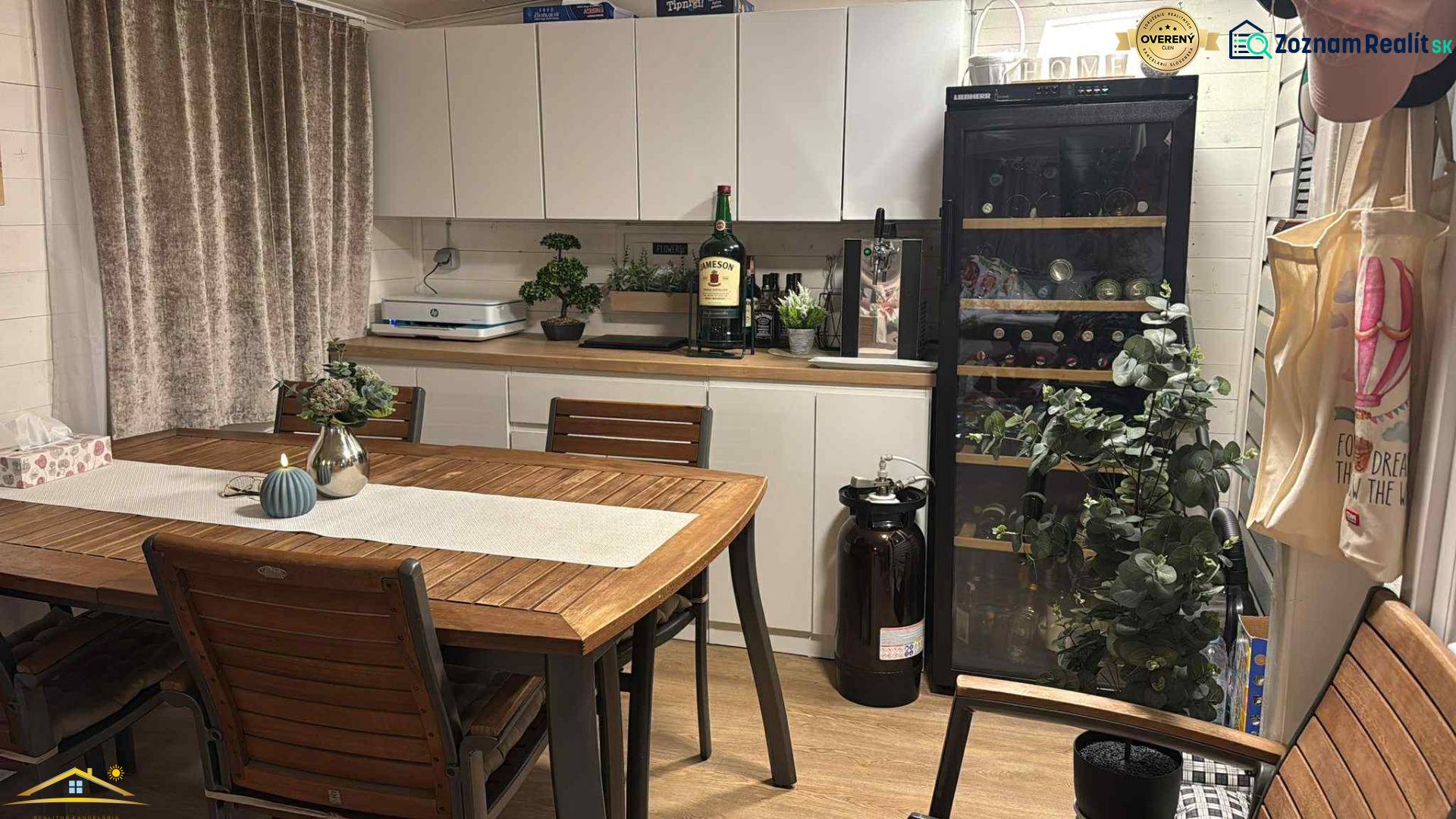 Dining area with a wine cooler and decorations, floor with wooden decor. Unique properties.