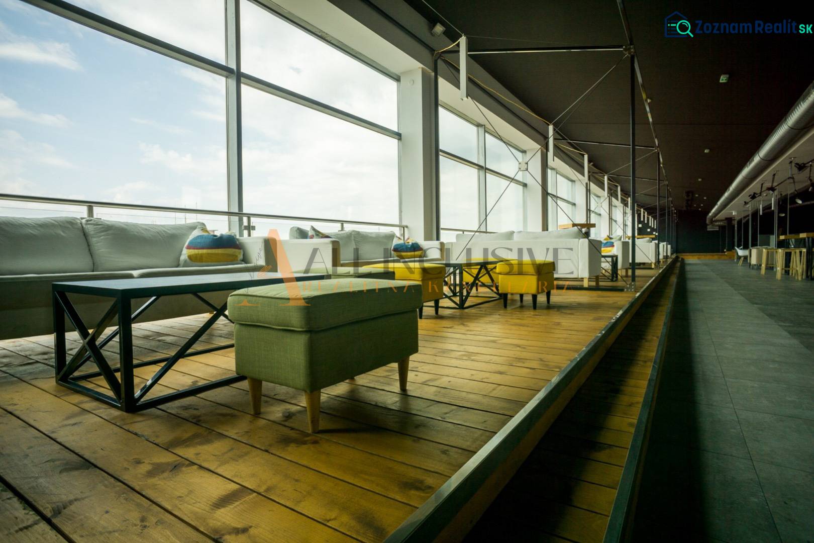 Comfortable seating with a wooden decor floor and large windows in dining areas.