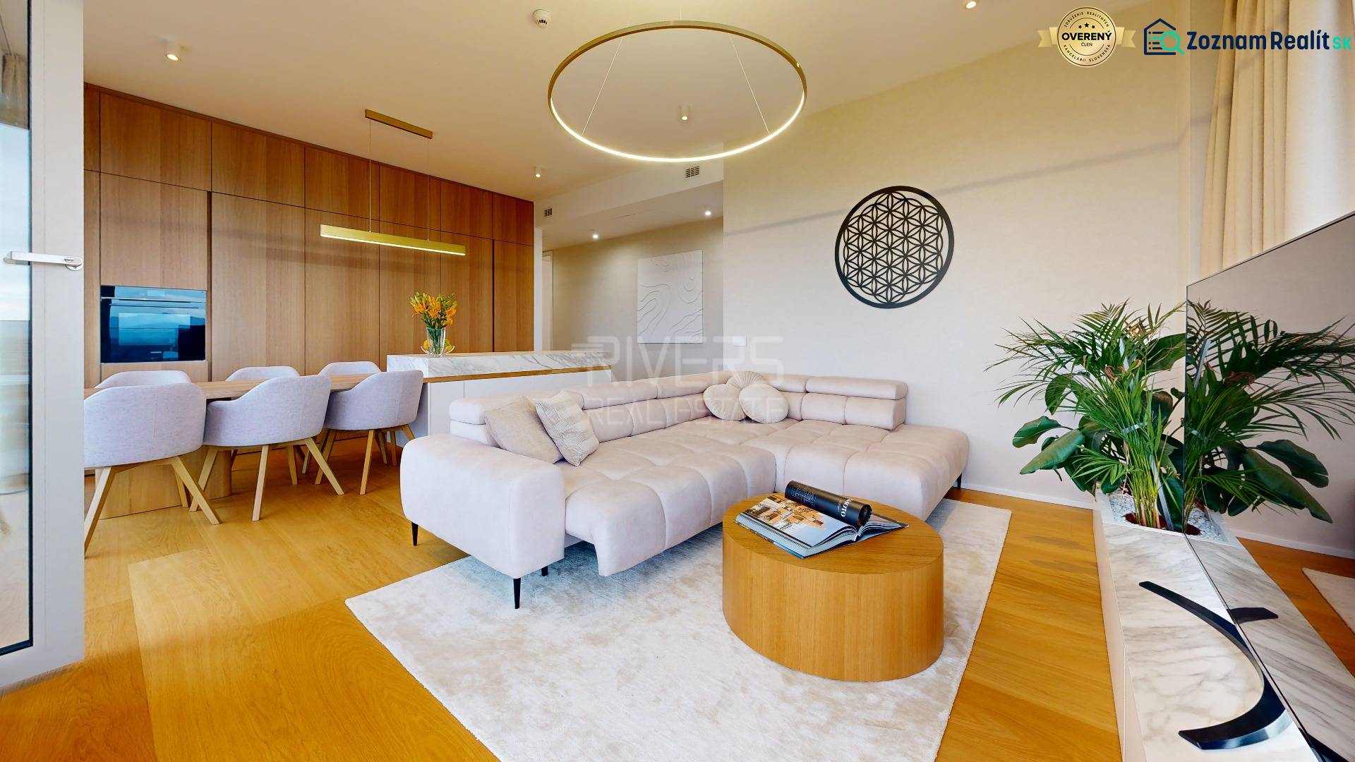 Living room in a 4-room apartment with a wood-patterned floor and a comfortable sofa.