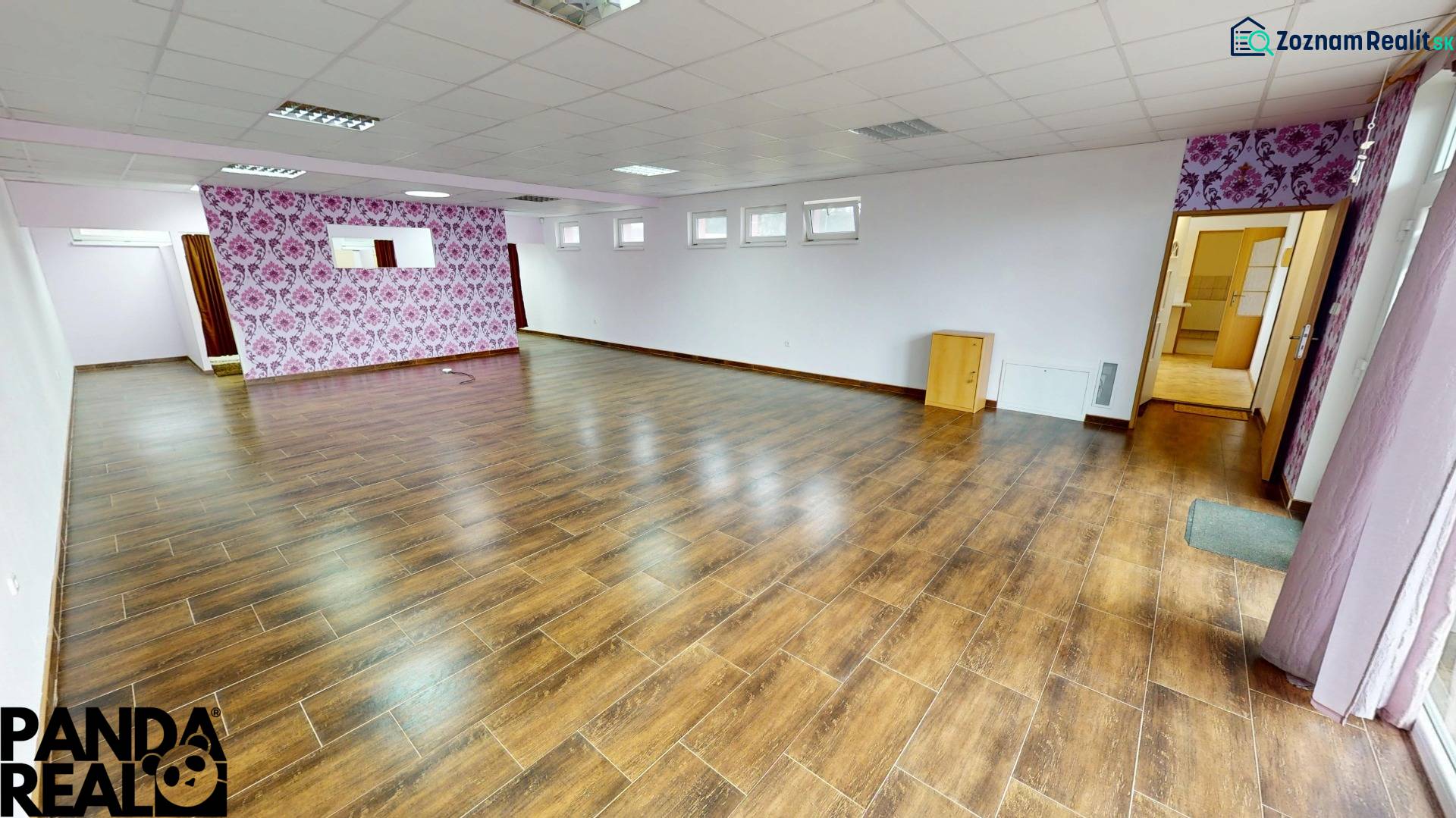 Interior of a family house with a wooden decor floor and floral wallpaper.
