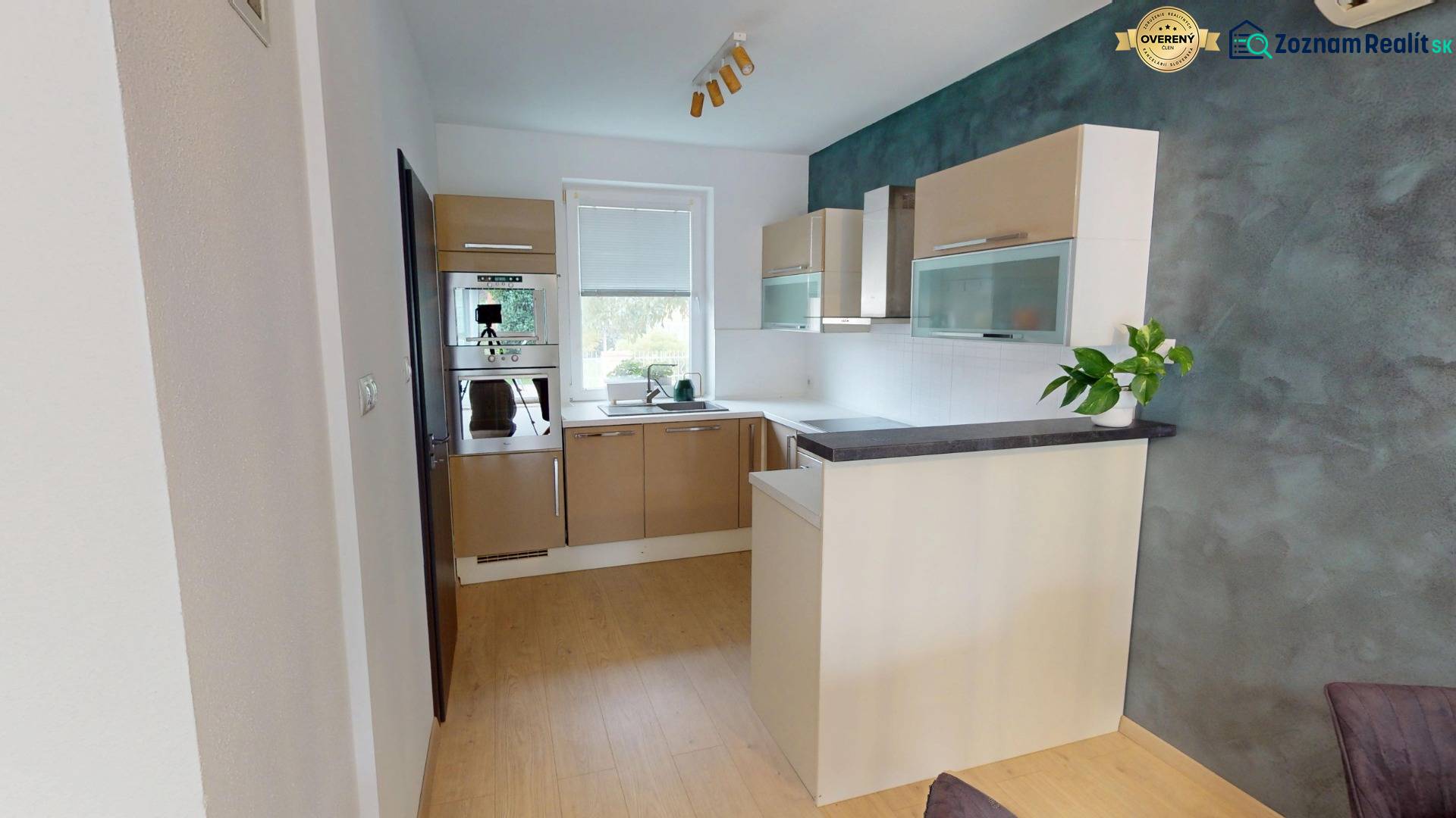 A kitchen in a family house with a wooden decor floor and modern equipment.