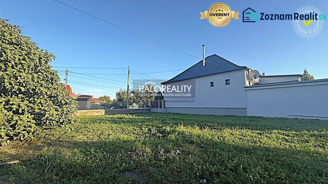Plots in Kameničná with grassy area and a white house, ideal for living.