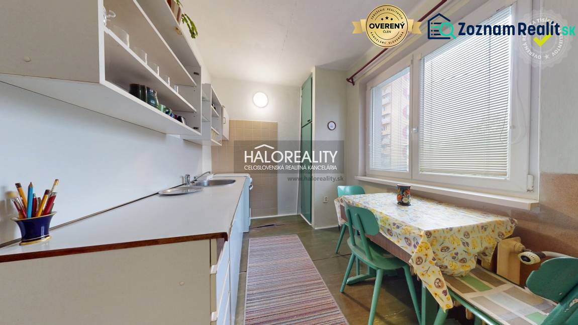 Kitchen in a 3-room apartment with a table and chairs, light decoration, practical arrangement.