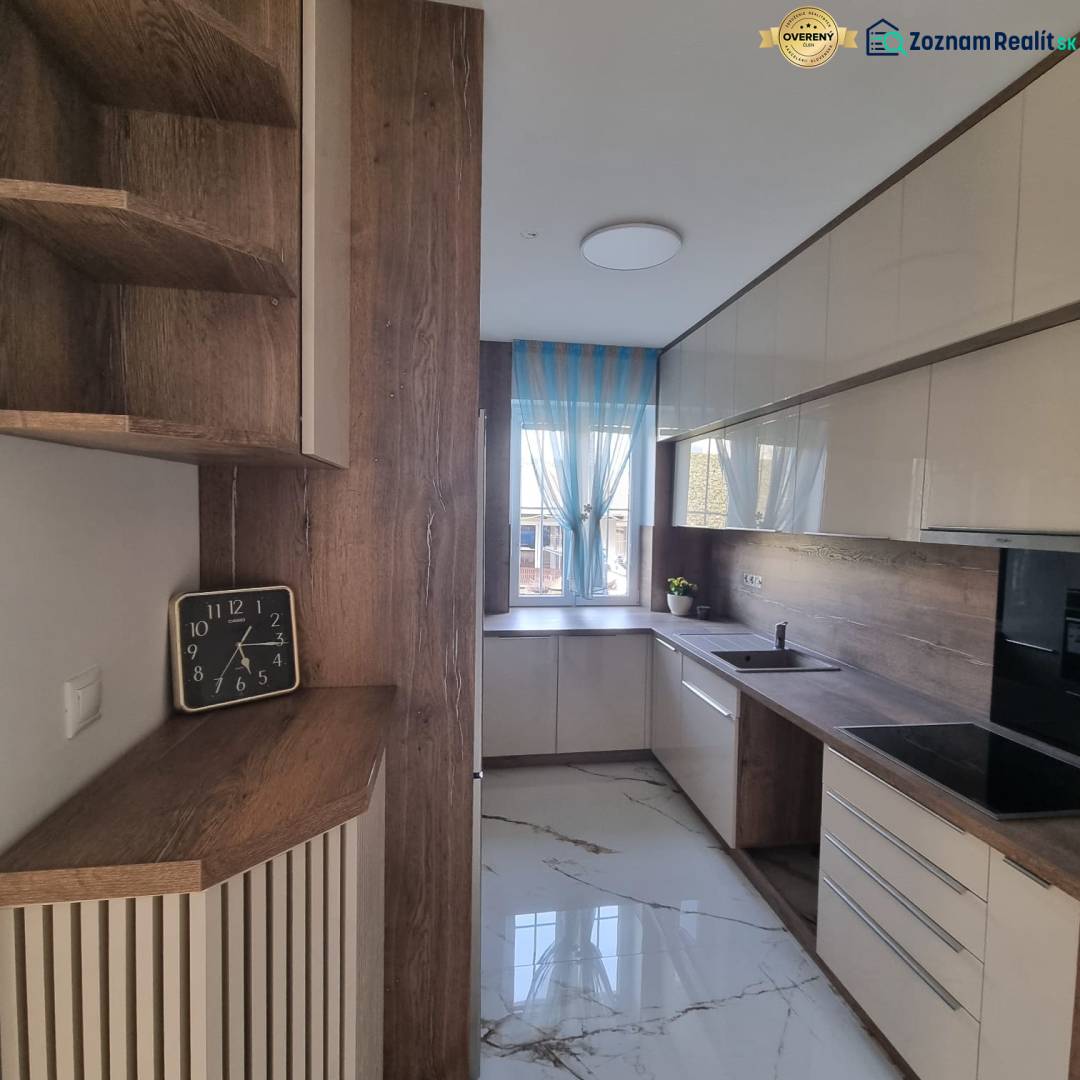 A stylish kitchen with wooden details, a spacious countertop, and modern equipment for a 3-room apartment.