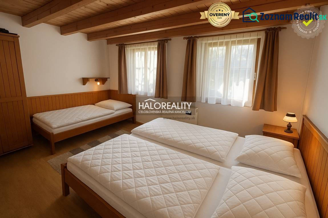 A bathroom in a cabin with tiled walls, a shower, a sink, and a mirror.