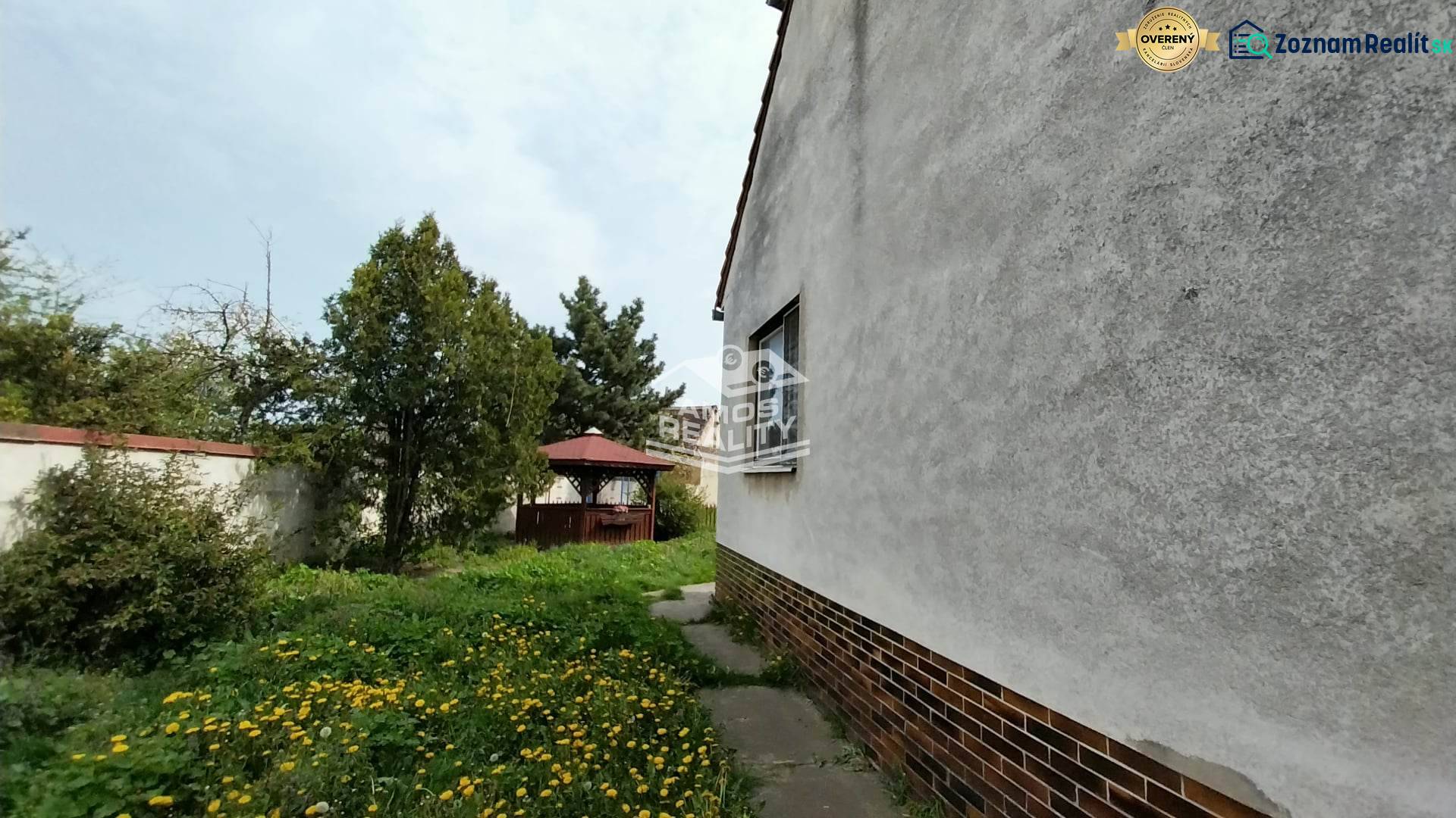 Family house with a terrace on Štúrova Street, garden with shrubs and trees.
