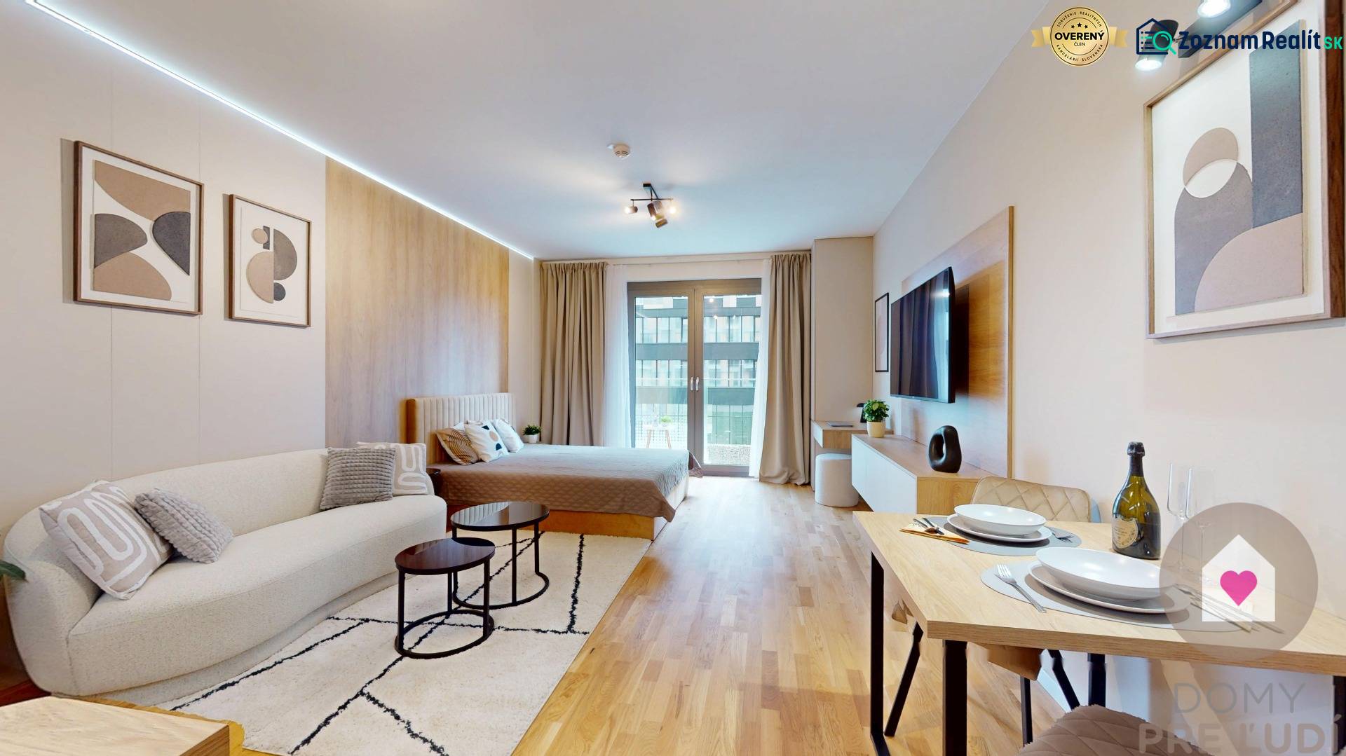 Living room with wood-patterned flooring, comfortable sofa, dining table, and bed.