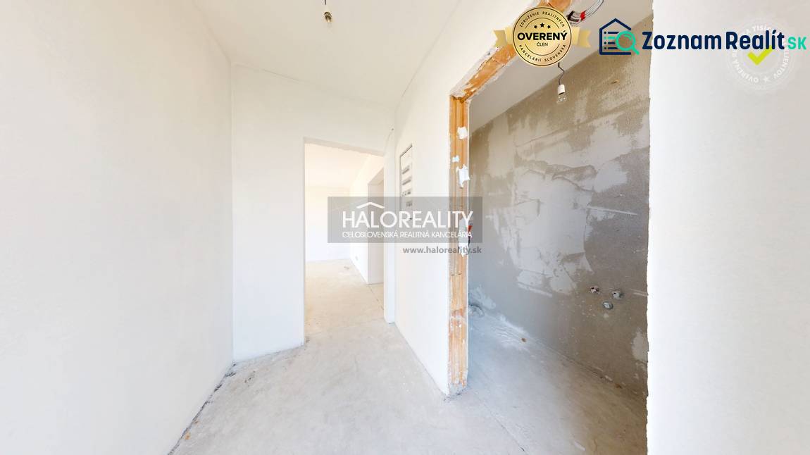 A hallway in a family house with unpainted walls and a room ready for renovation.
