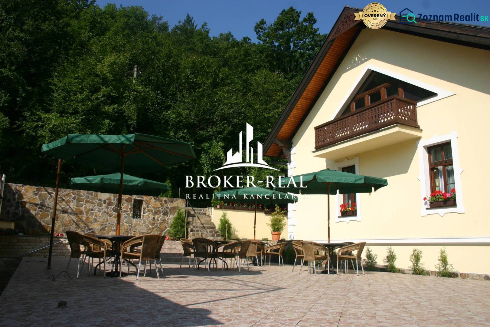 Terrace at the guesthouse in Košice - Sever with rattan furniture and umbrellas.