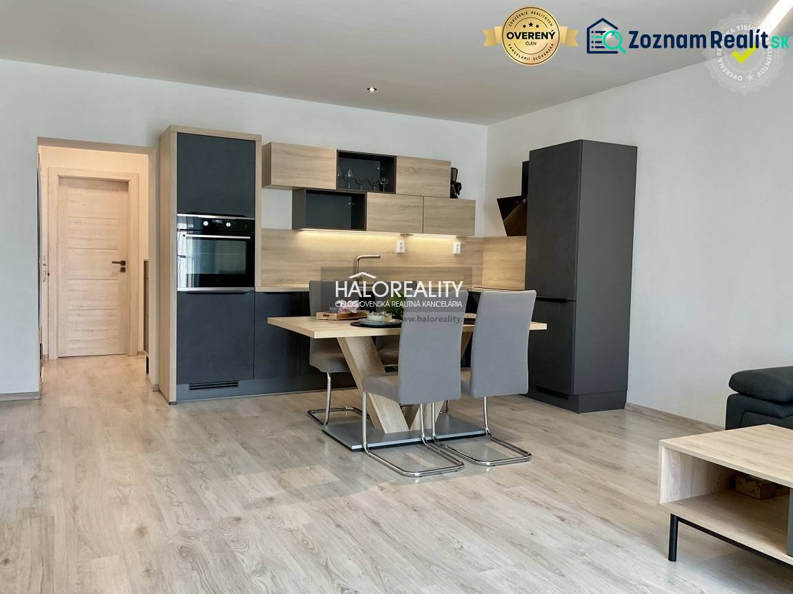 A kitchen in a 3-room apartment with a kitchenette and a dining table, flooring with a wooden decor.