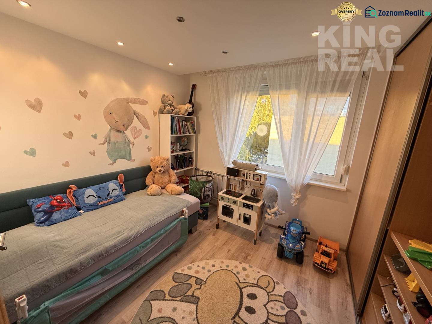 Children's room with a pull-out bed, toys, and shelves in a 3-room apartment.