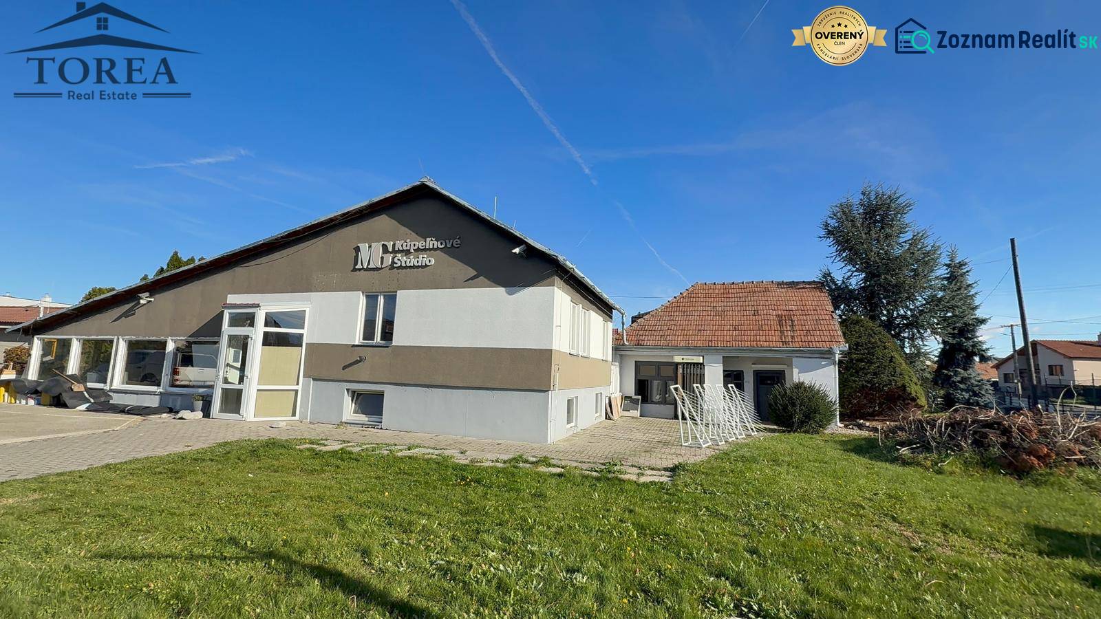 Commercial premises in Dolné Chlebany with a green lawn and a sloped roof.