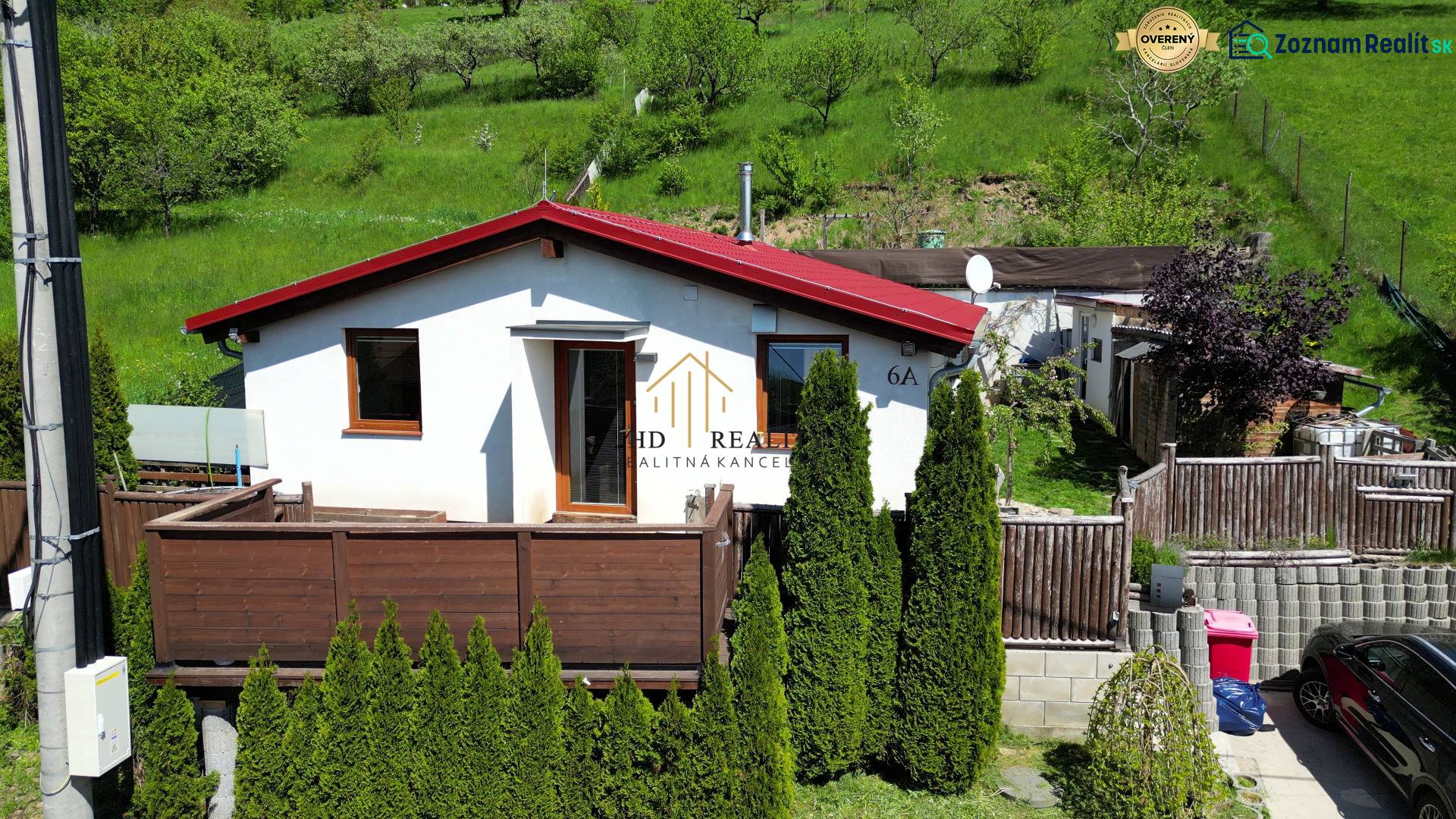 A family house on 8. mája Street 2810/6A in Banská Štiavnica surrounded by greenery and a terrace.