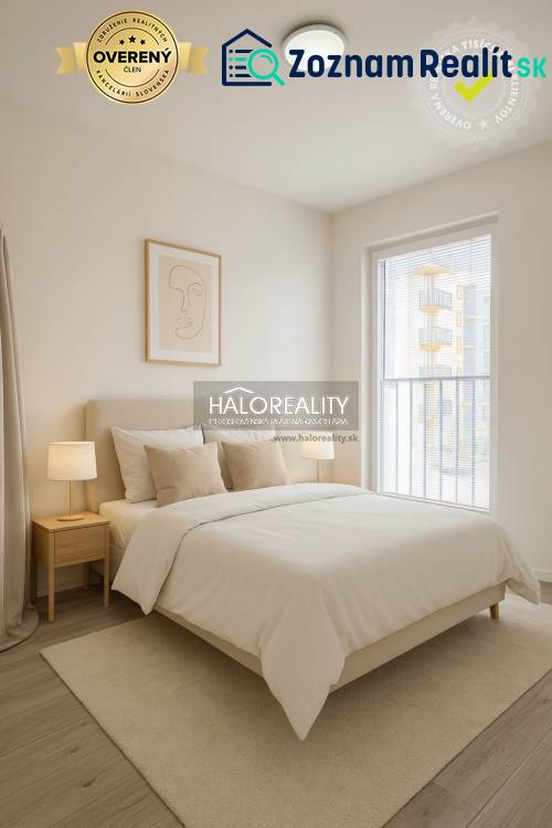 Bright bedroom in a one-room apartment with wood-patterned flooring and a large window.