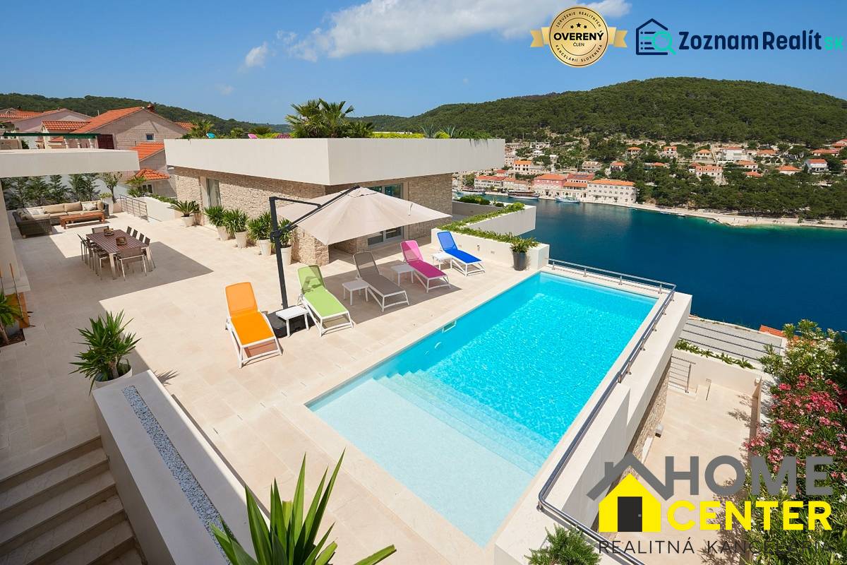 Villa in the town of Bol with a pool, terrace, colorful loungers, and a sea view.