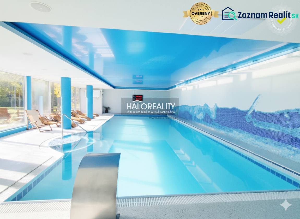 A pool with blue ceilings and loungers in indoor dining areas.