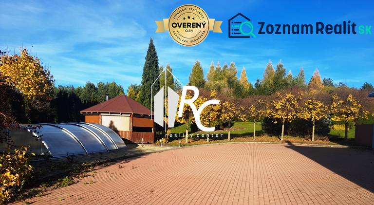 A view of the garden of a family house in Necpaly with a paved area and a swimming pool.