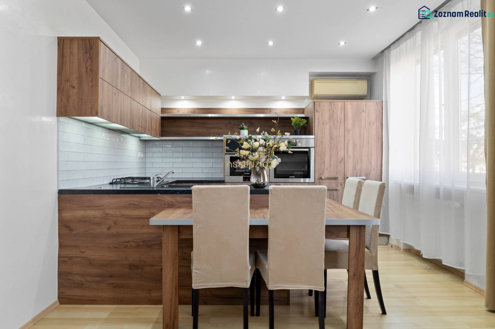 A kitchen in a 2-room apartment with wooden decor and light furniture.