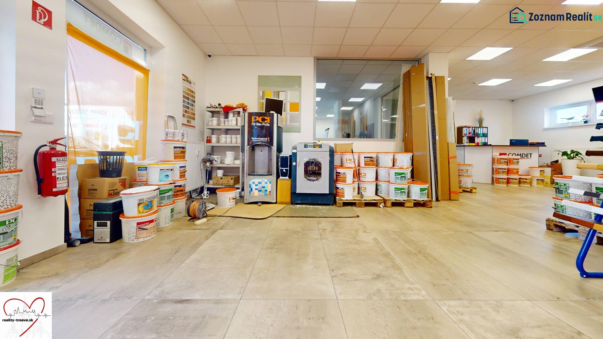 Commercial premises with wood-patterned flooring, plastic buckets, and paint mixing machines.