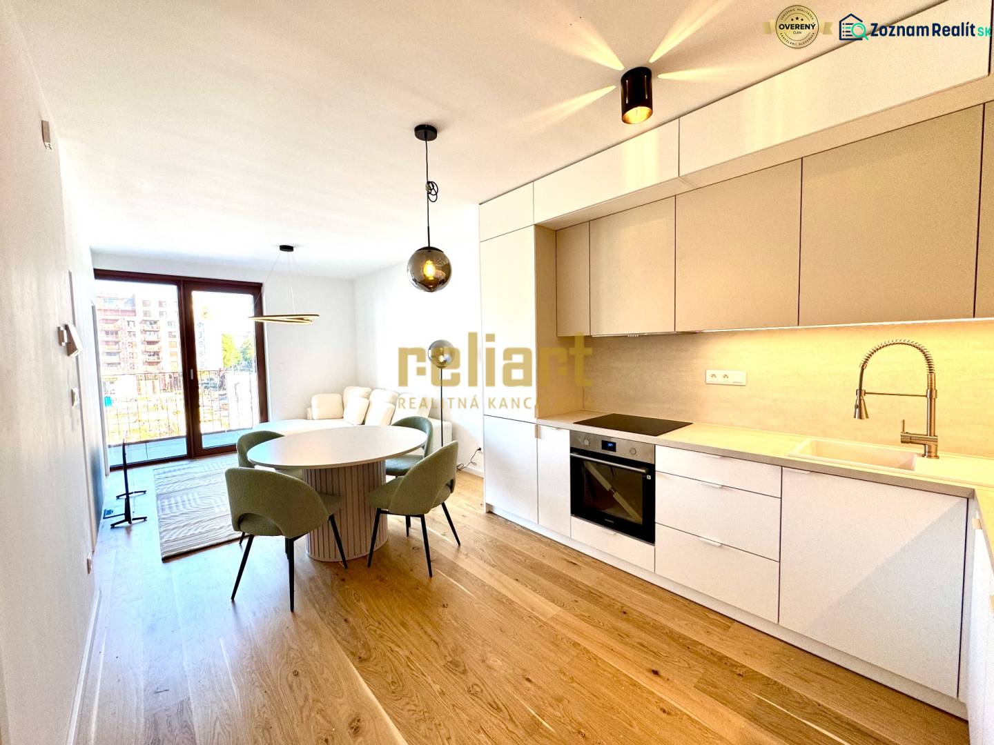 Kitchen unit, dining table, wooden decor flooring in a 2-room apartment.