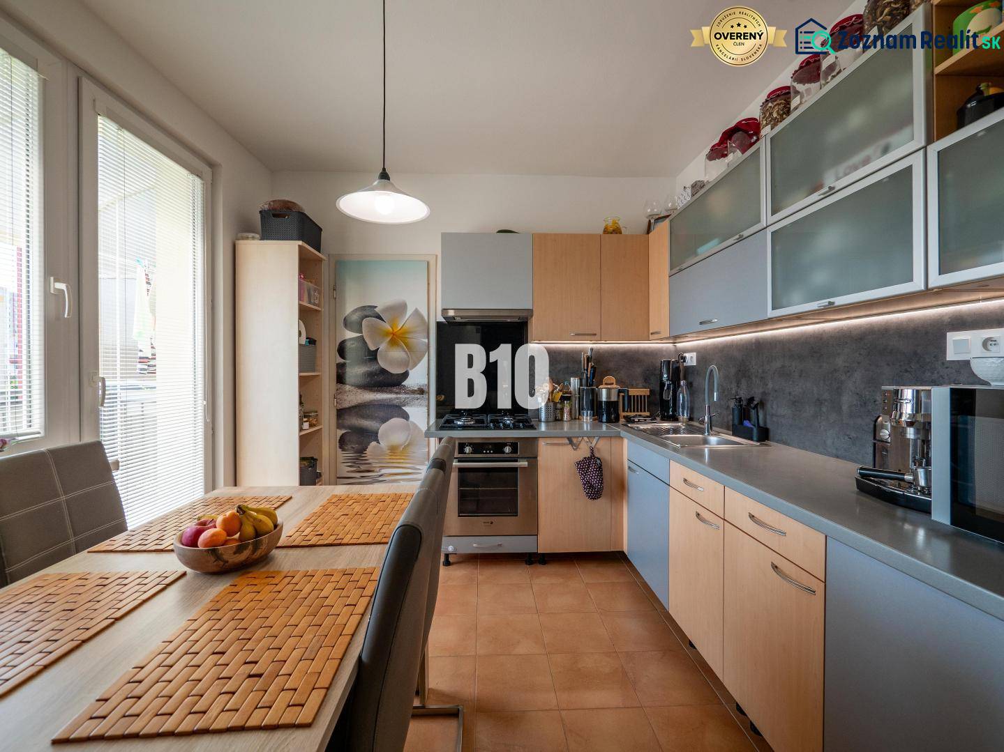 A kitchen in a 4-room apartment with a dining table and built-in appliances.