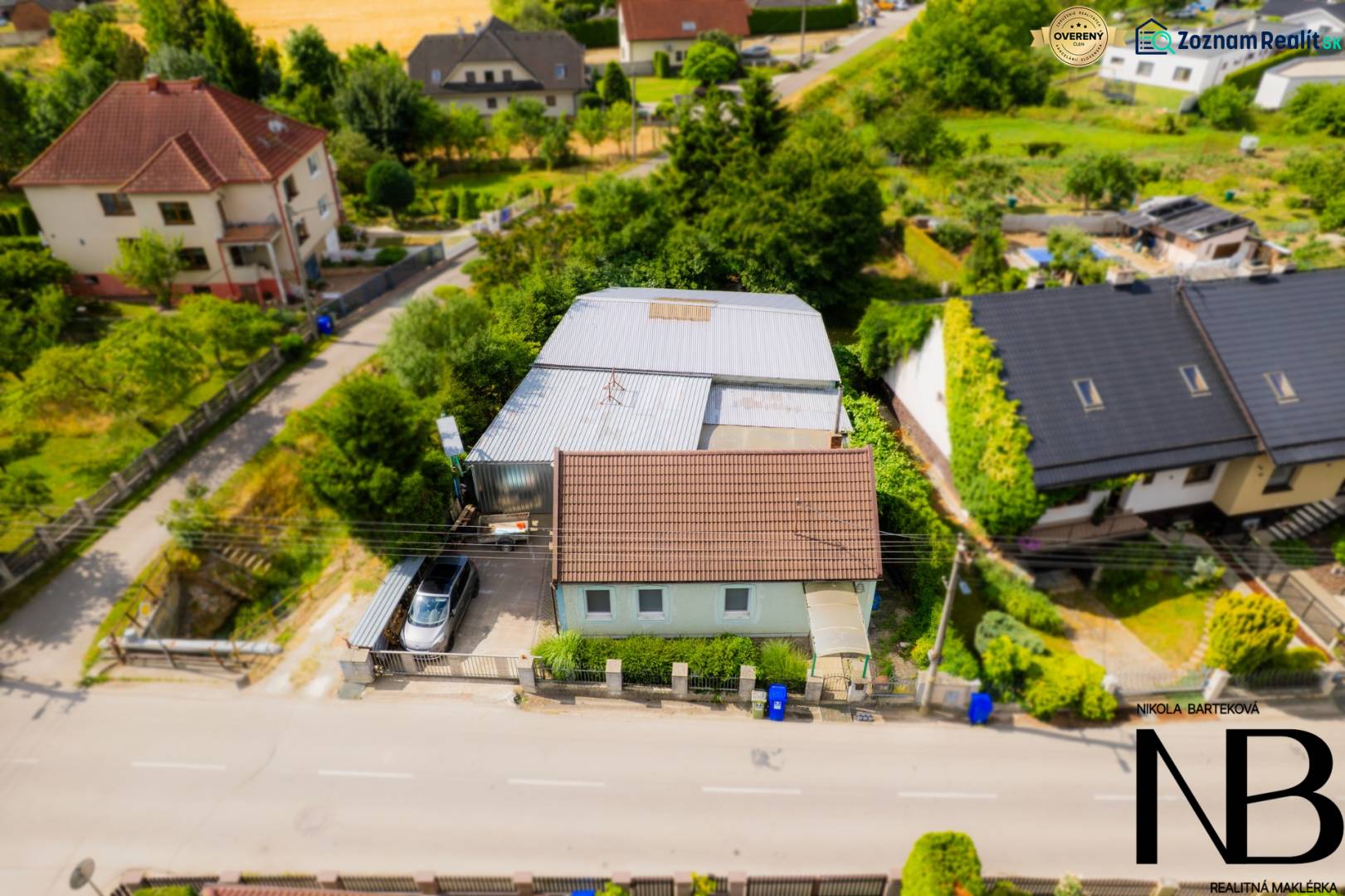 A family house on Záblatská Street in Trenčín, surrounded by greenery and other houses.
