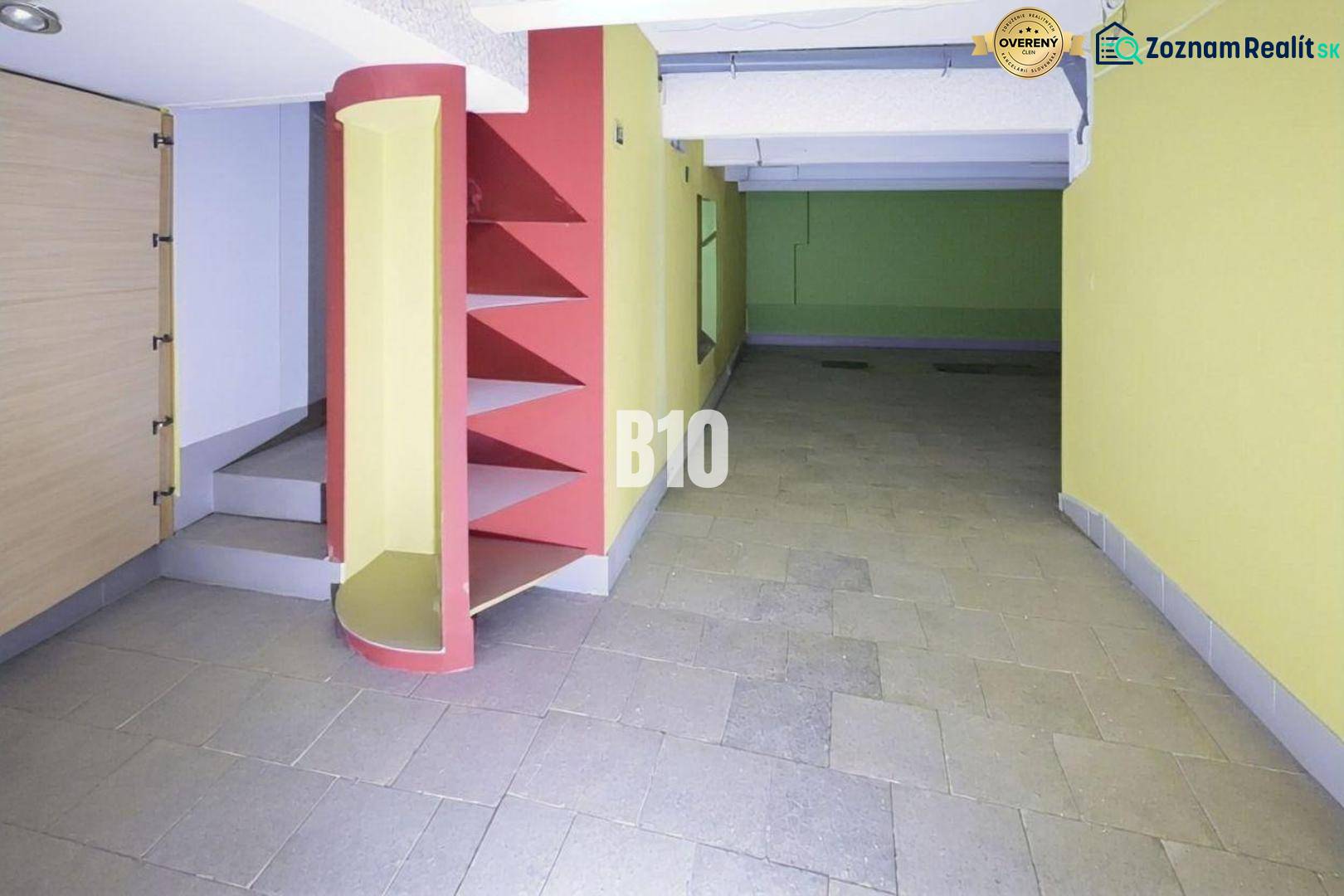 Interior of commercial spaces with colorful walls, shelves, and stairs on the tiles.