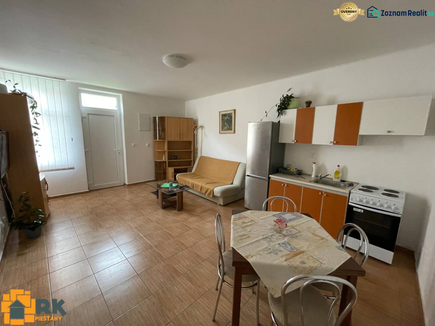 Interior of a family house with a kitchenette and a wooden decor floor.