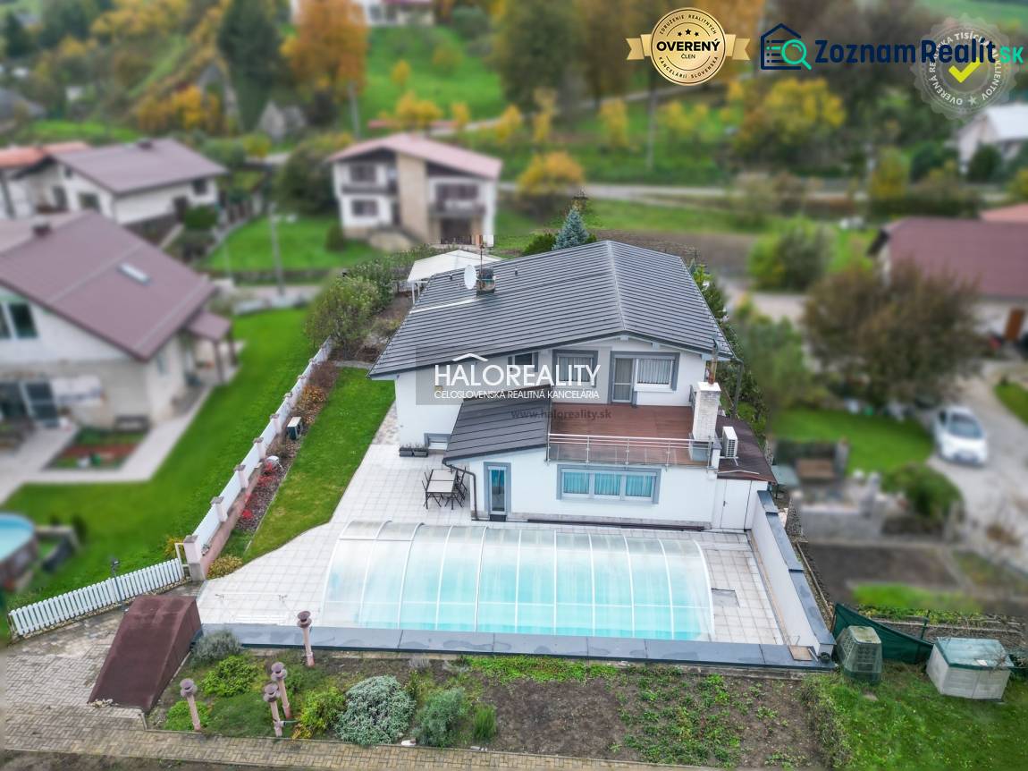 A family house in Domaniža with a garden and a swimming pool, surrounded by greenery and neighboring houses.
