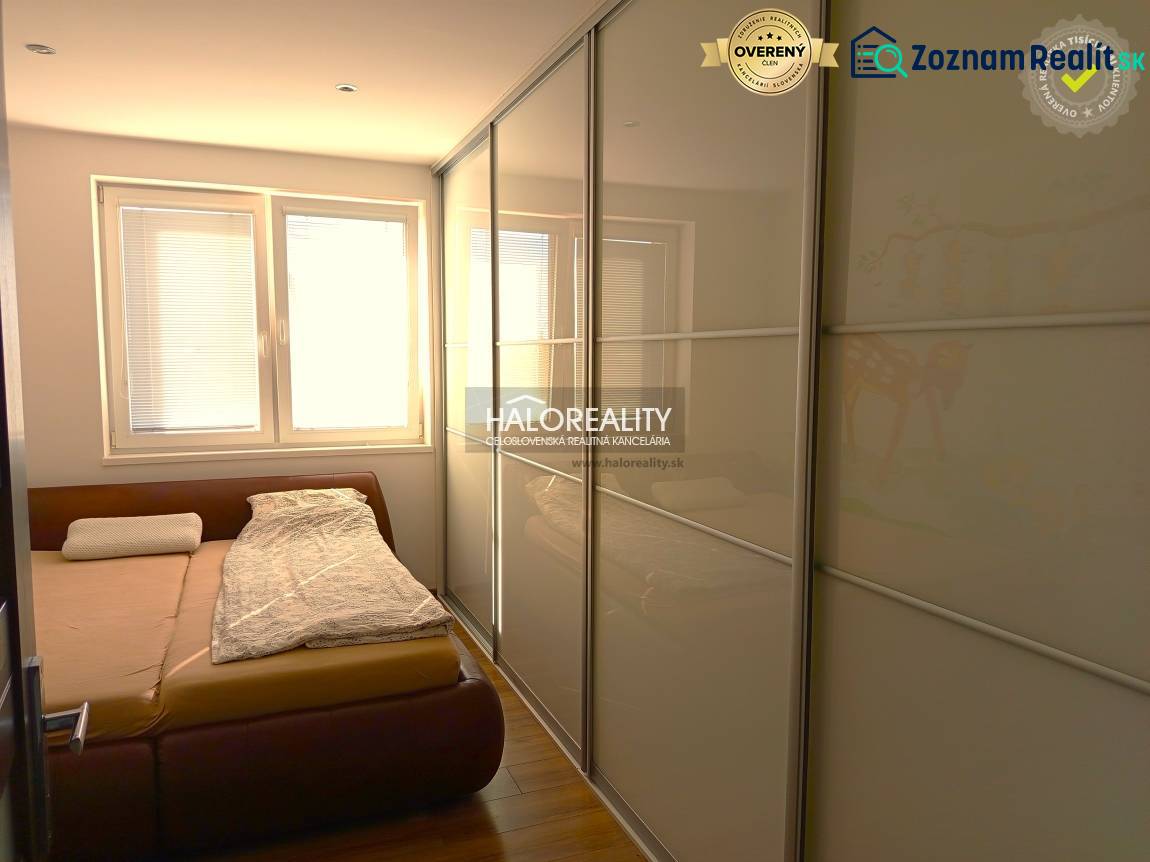 Bedroom in a 3-room apartment with a large wardrobe and a floor with a wooden decor.