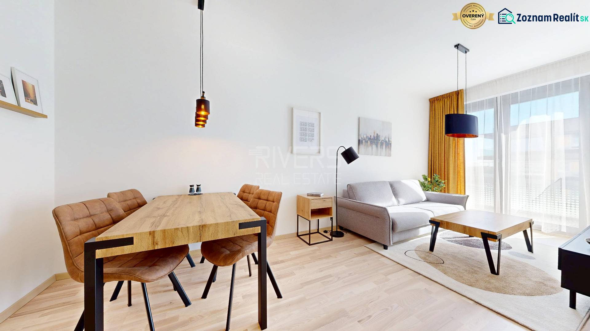 Living room in a two-room apartment with a wooden decor floor and a dining table.