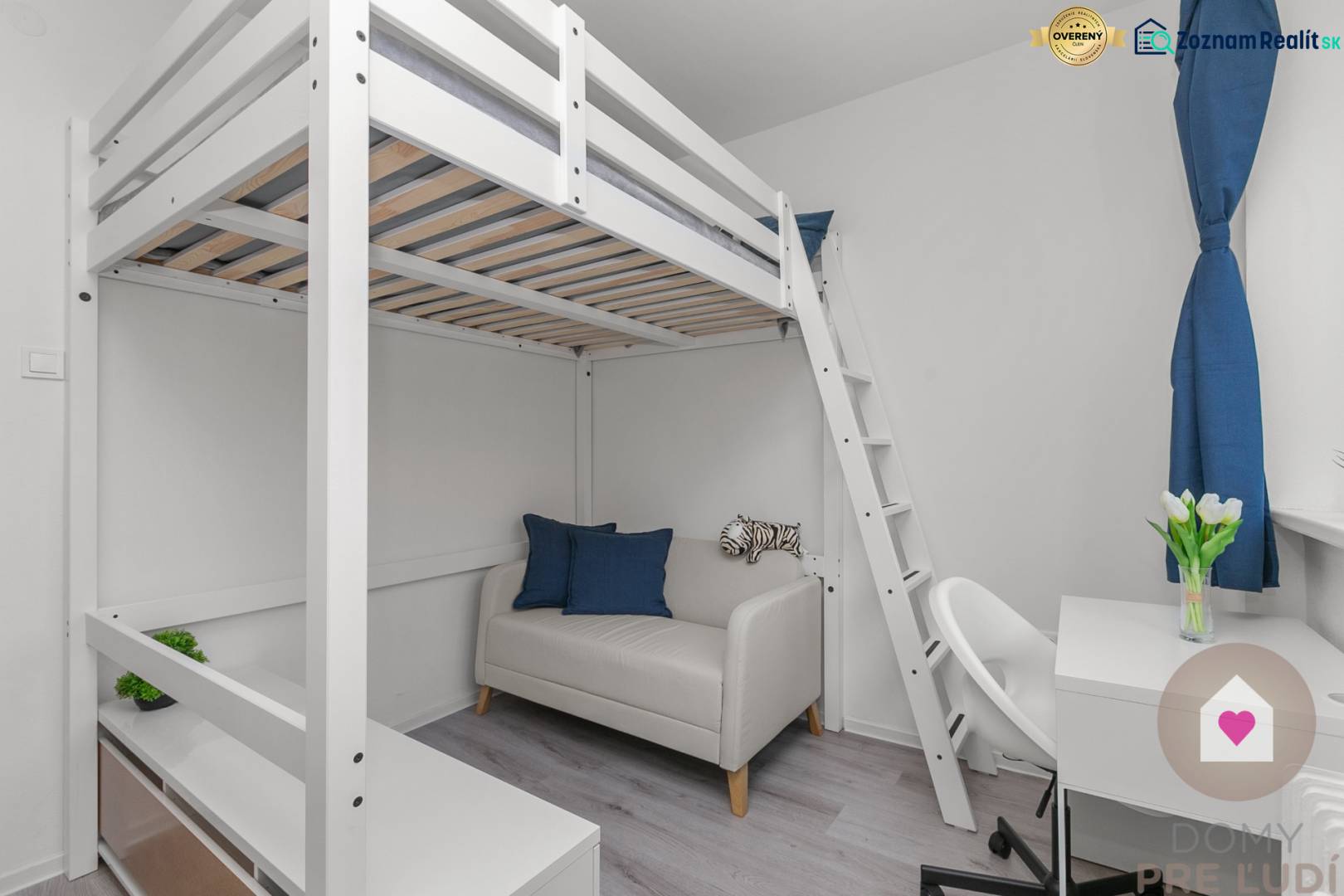 Studio apartment with a loft bed, sofa, table, and white furniture, floor with wood decor.