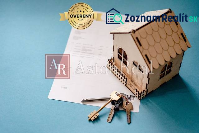Keys to a 3-room apartment and a model house placed on a blue background.