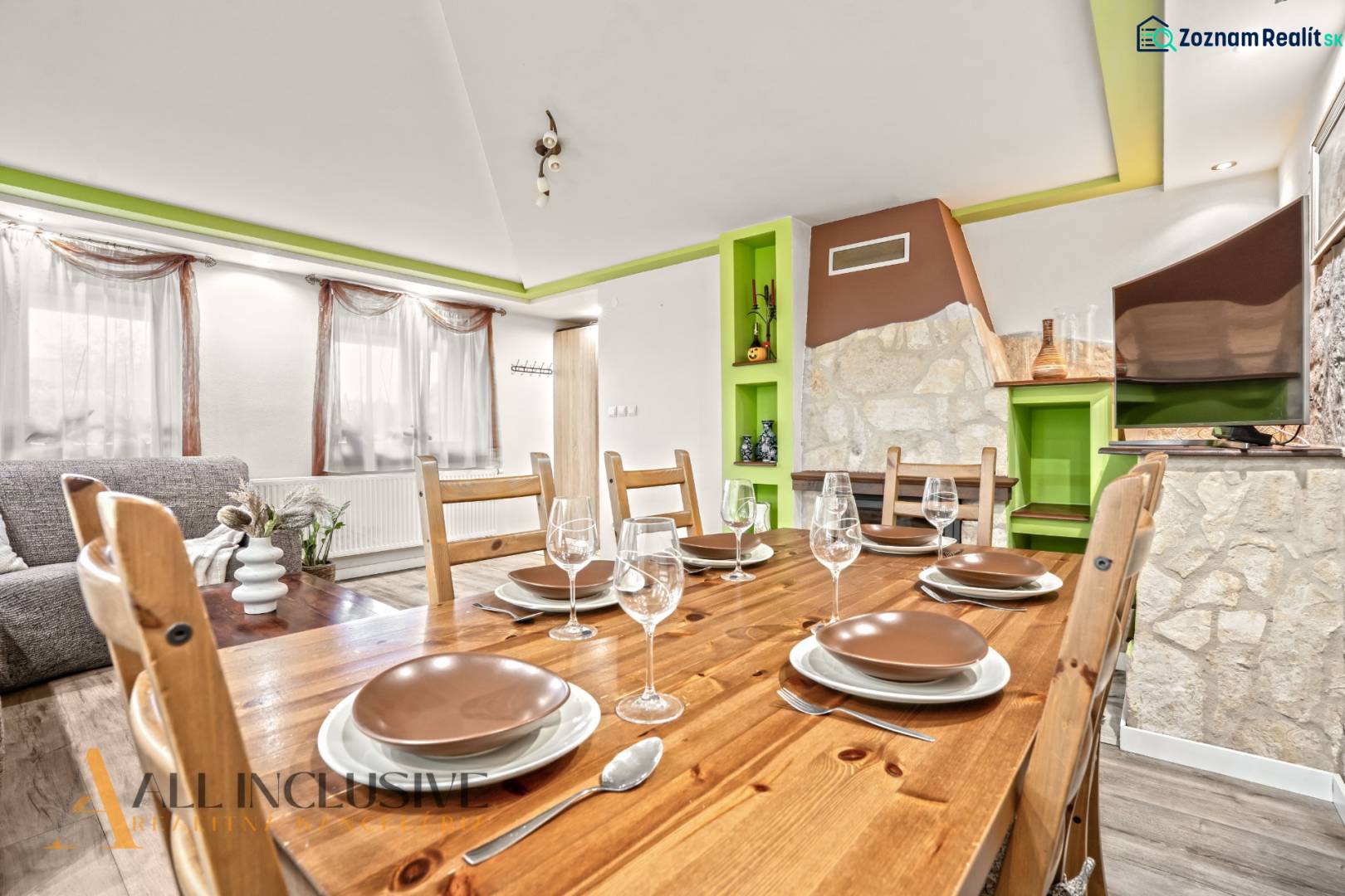 Dining room in a family house with a wooden table, glasses, and a decorative fireplace.