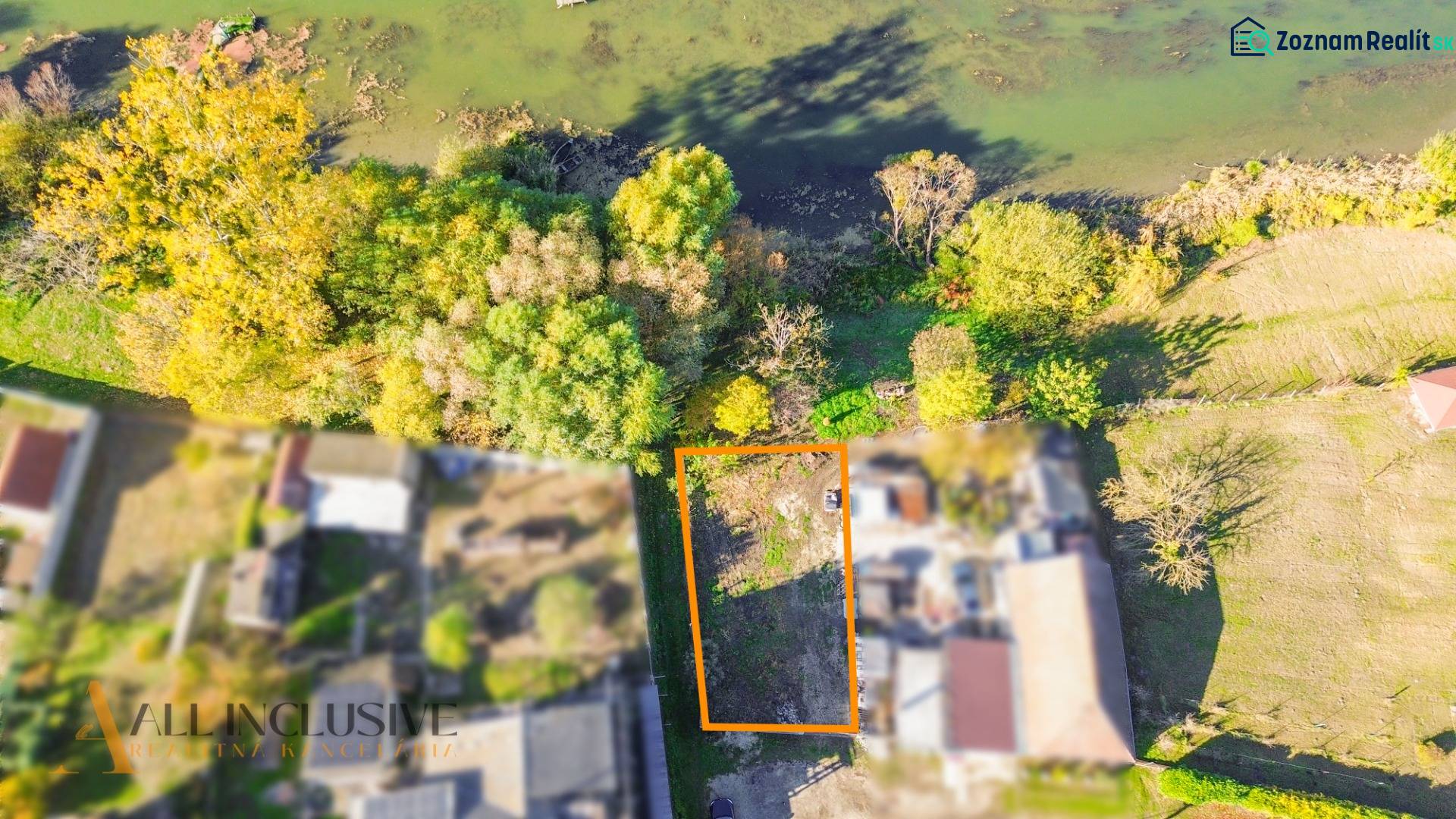 Aerial view of a residential plot in Jahodná, surrounded by greenery near the water.