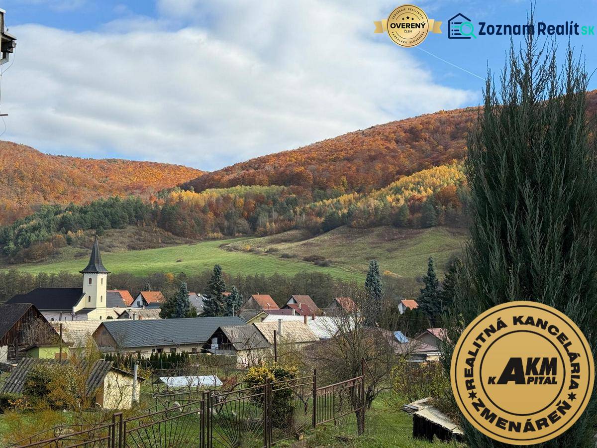 A church and family houses in the picturesque autumn landscape of Stará Kremnička.