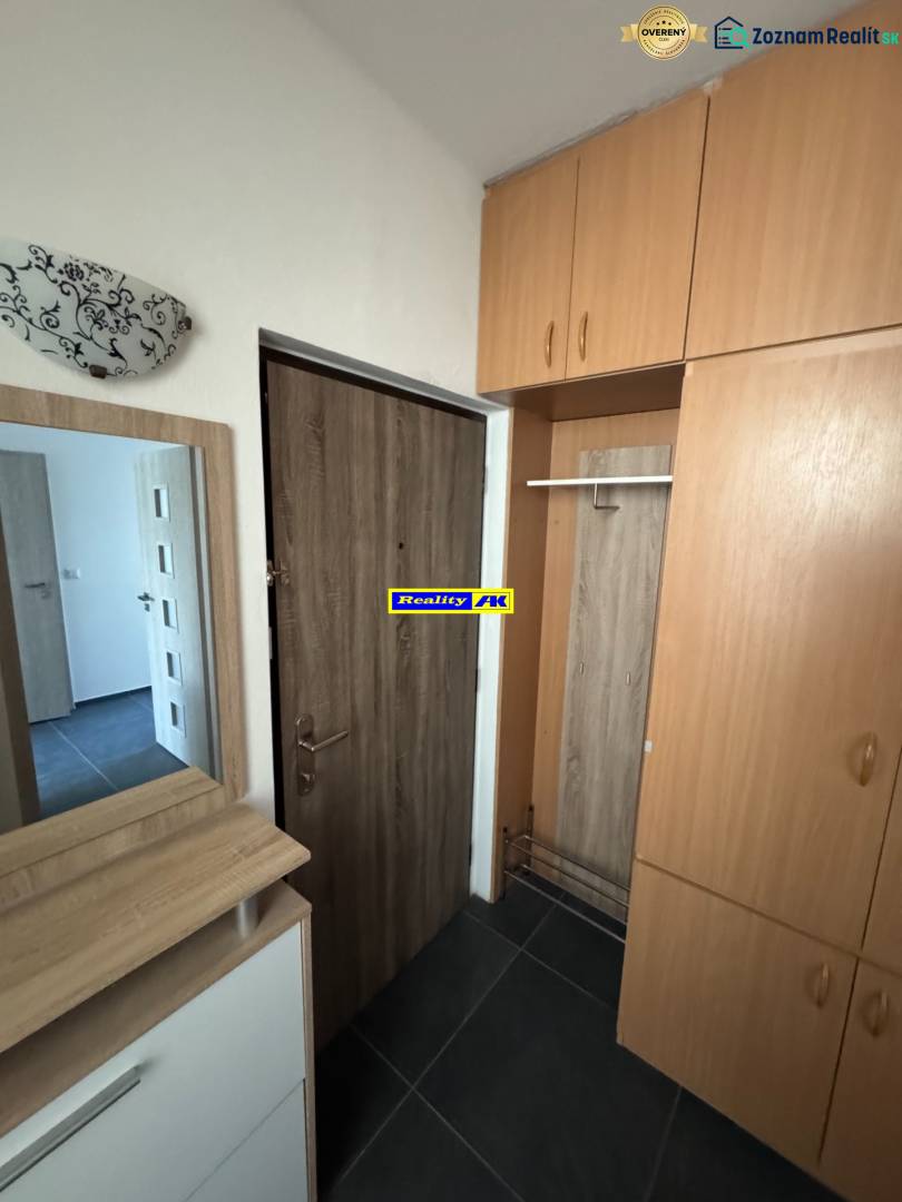 Entrance hall with storage space in a 3-room apartment, floor with wood decor.