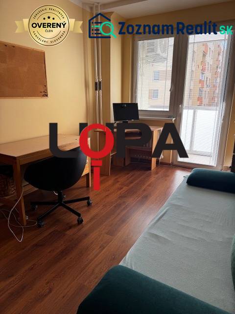 A workspace in a 3-room apartment with a wooden decor floor, bright room.