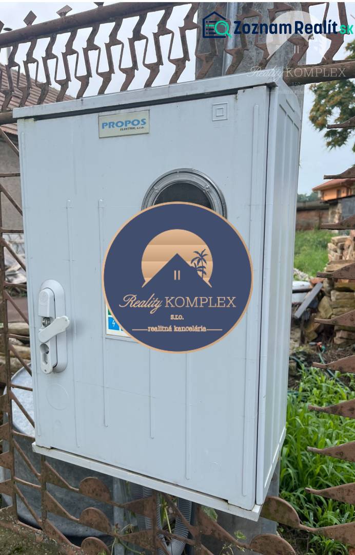 Electrical cabinet near residential plots in Iža, suitable for infrastructure.