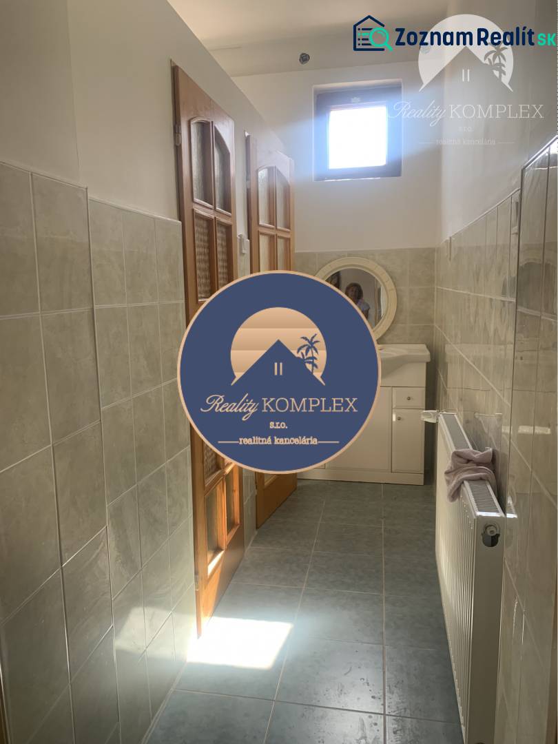 Bathroom with tiles, sink, and wooden door in the area of Warehouses and halls.